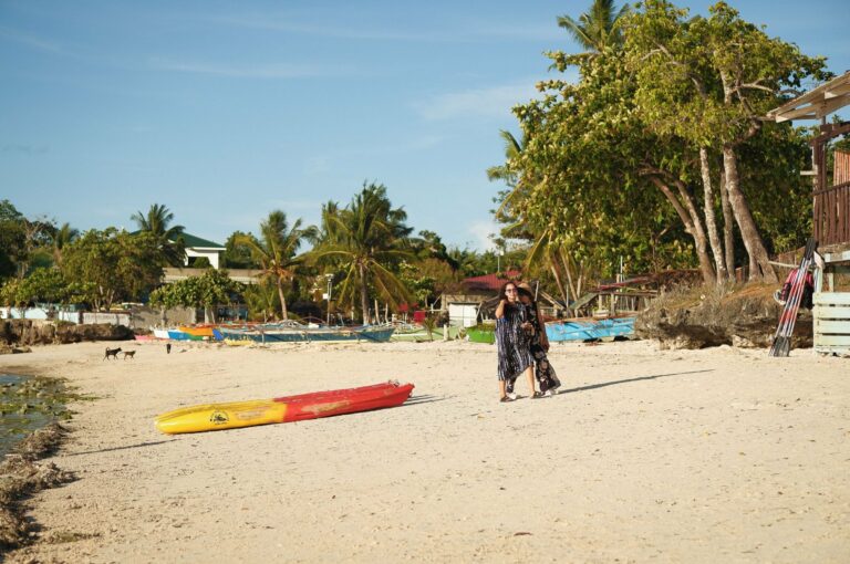 A beach with colourful boats in the central Philippines