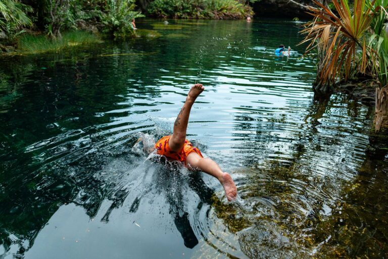 A child diving into a cenote near Playa del Carmen