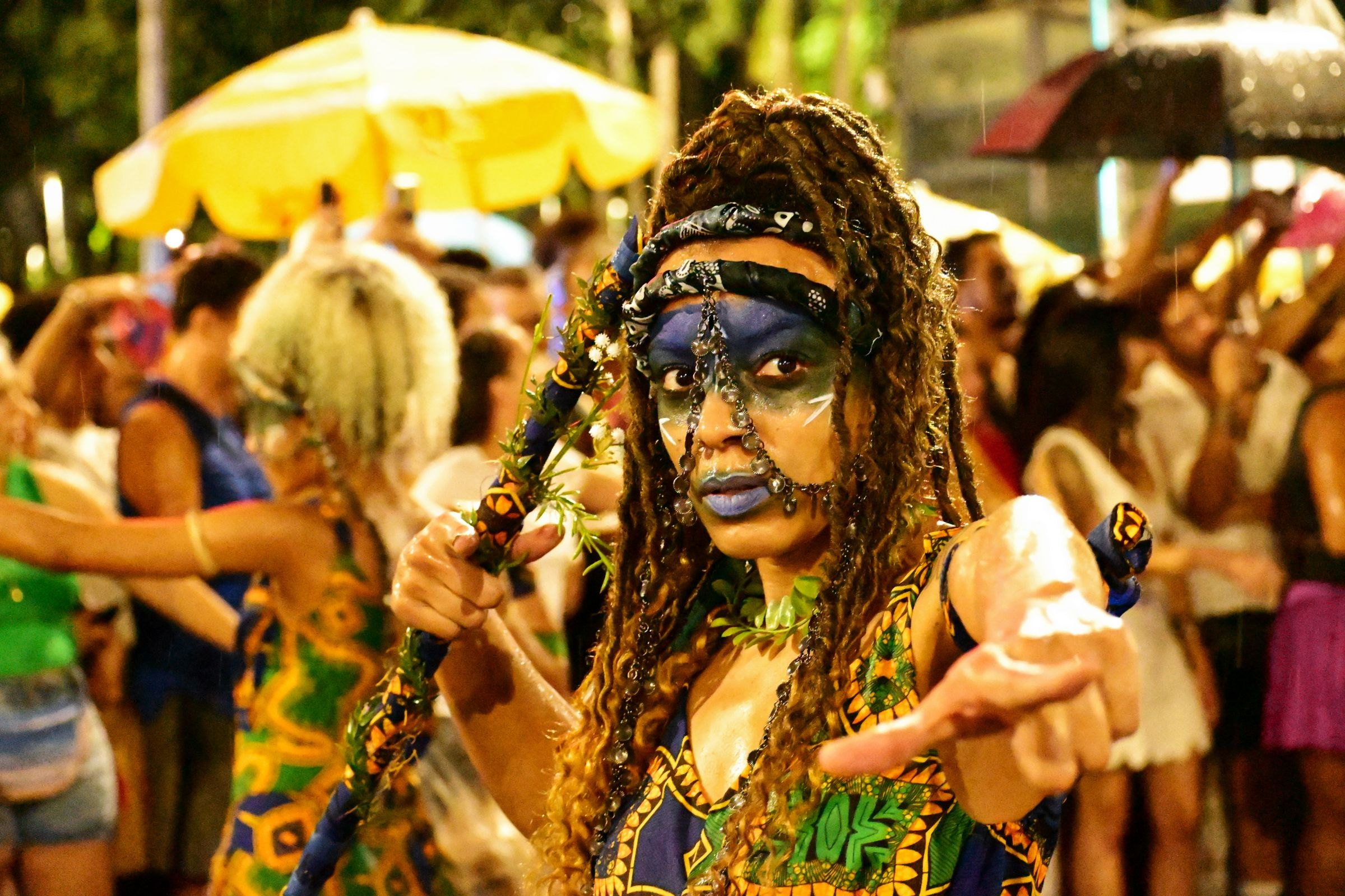 A costumed performer at a carnival street party