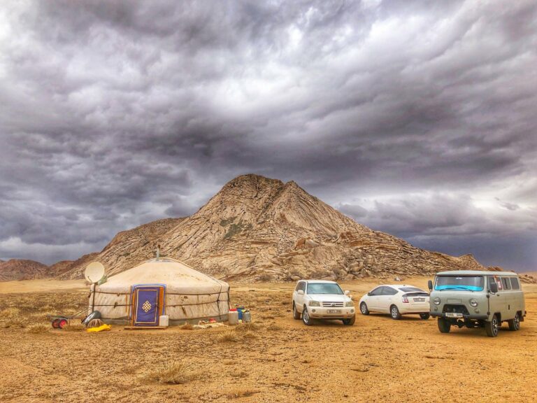 A ger camp below a mountain in the Gobi