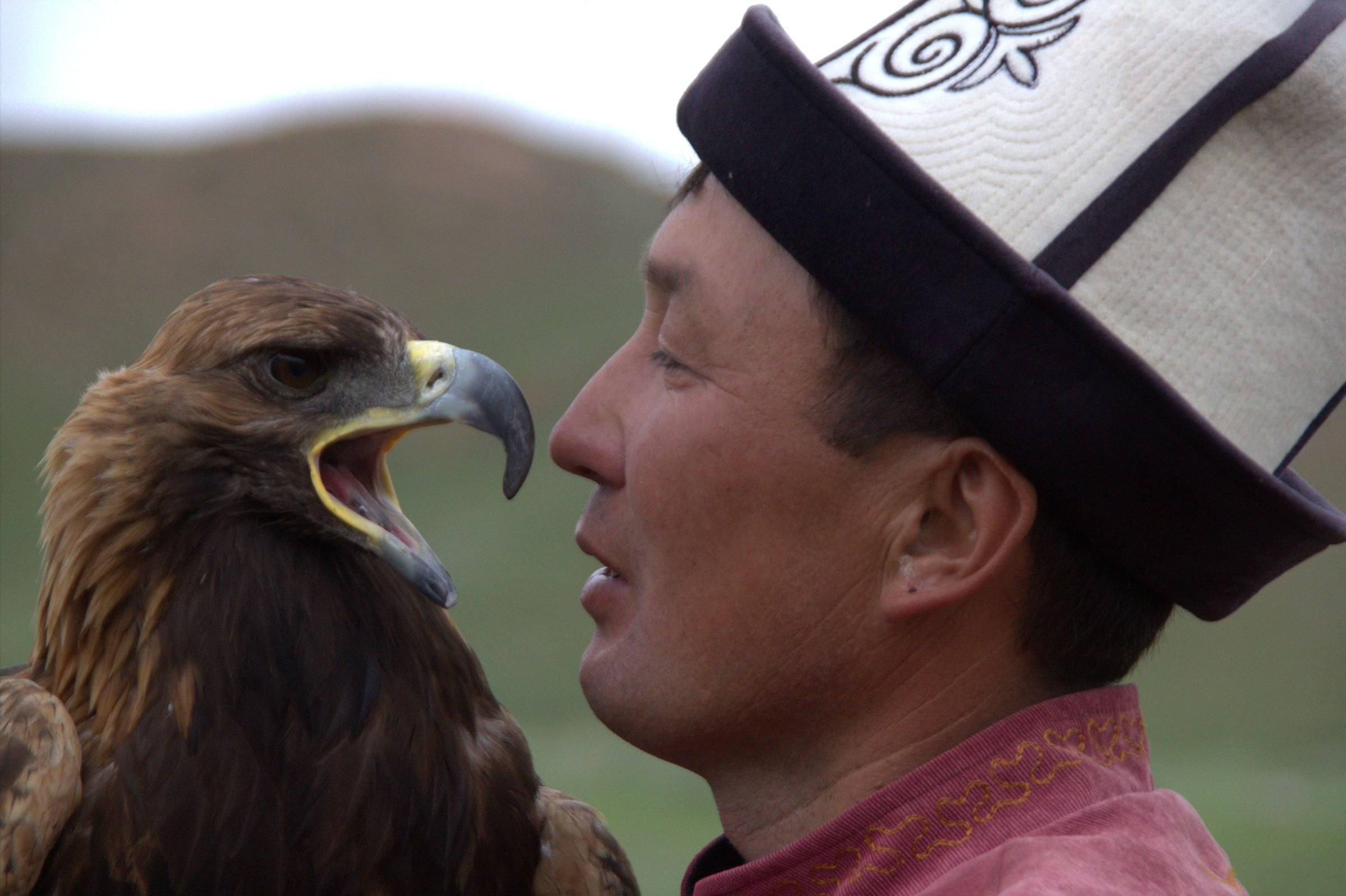 A Kyrgyz eagle hunter with his golden eagle