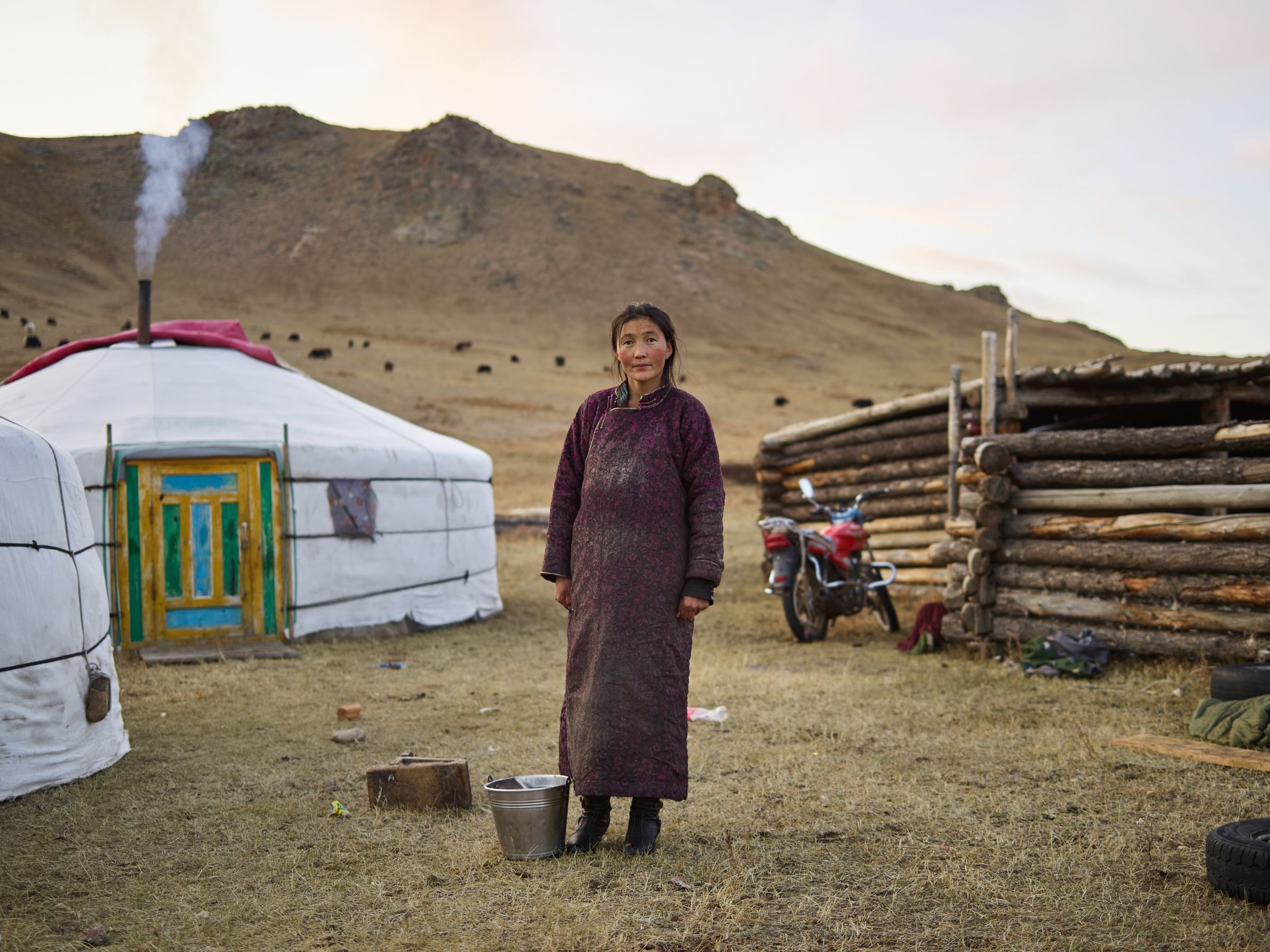 A Mongolian herder outside her ger