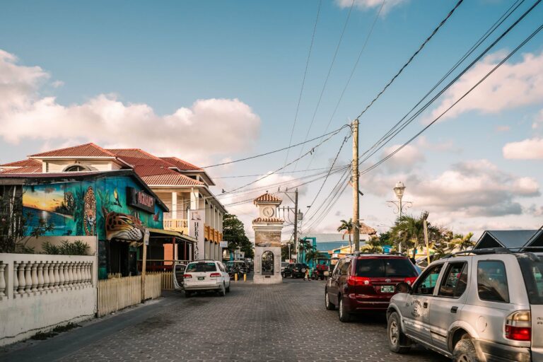 A street with murals and a clock tower in Belize