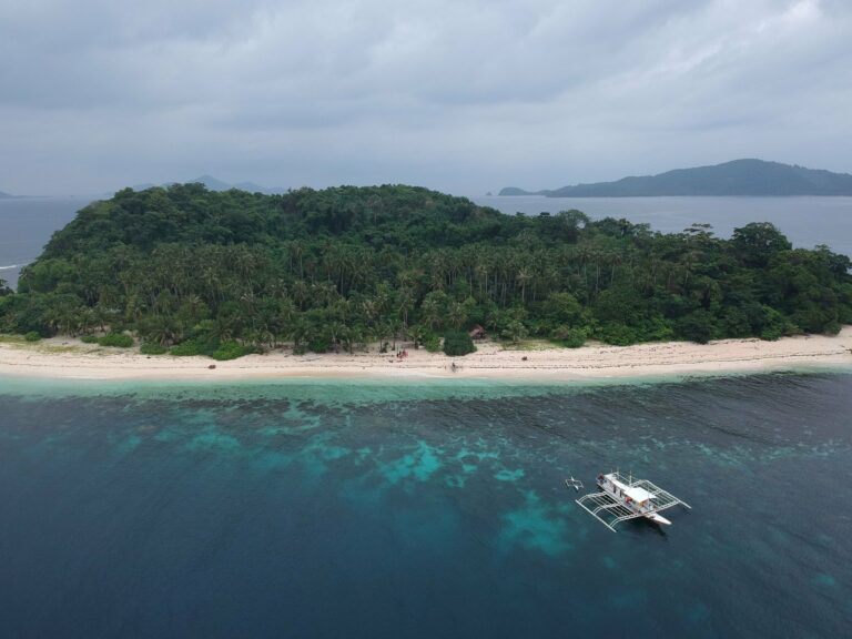 A tropical island and outrigger boat