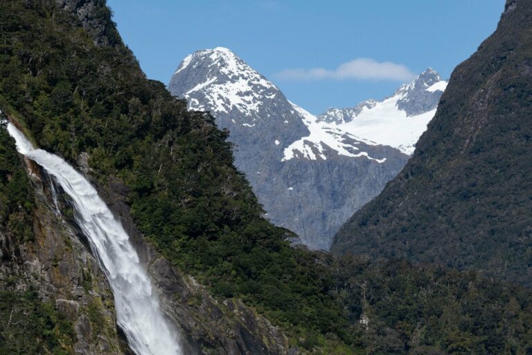 A waterfall below snowy peaks in Fiordland