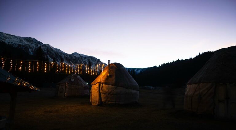 A yurt camp lit up in the Kyrgyz mountains