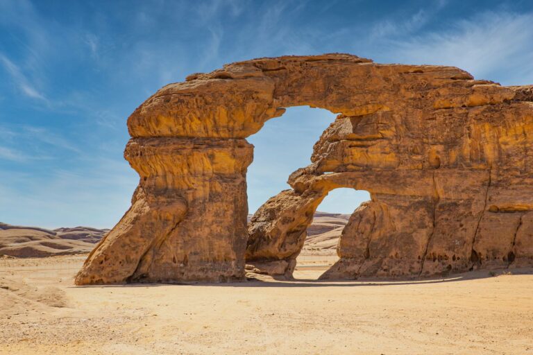 A natural rock arch in the desert near AlUla
