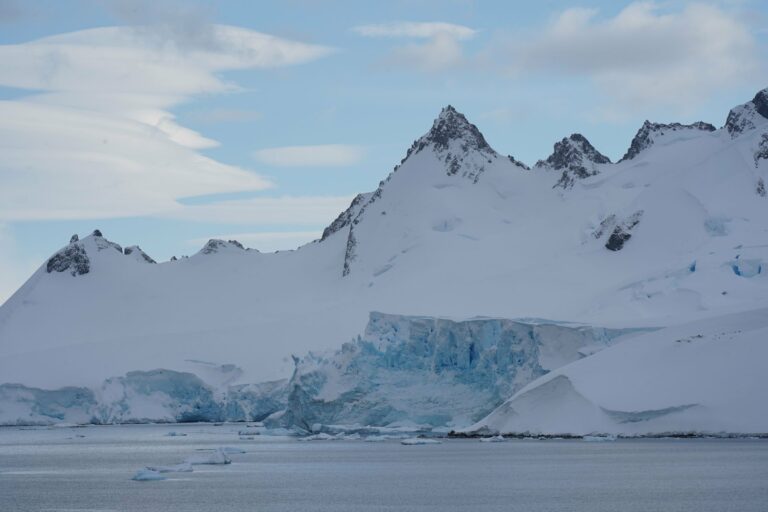 An Antarctic glacier beneath rugged peaks