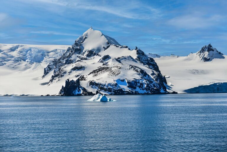 A snow-covered mountain and iceberg in Antarctica