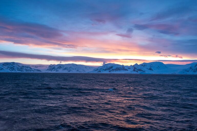 Sunrise over Antarctic mountains and sea