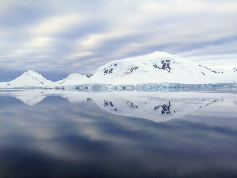 Snowy mountains reflected in Arctic waters