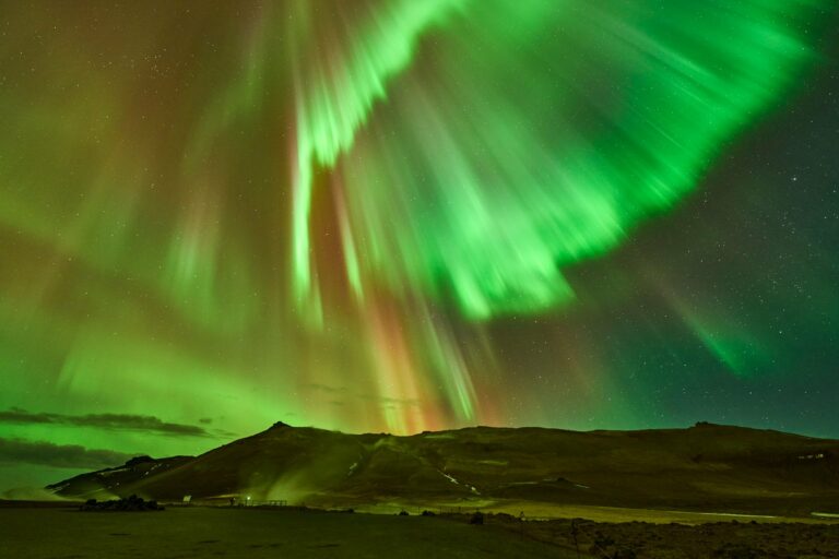 The aurora borealis over Iceland's rugged land