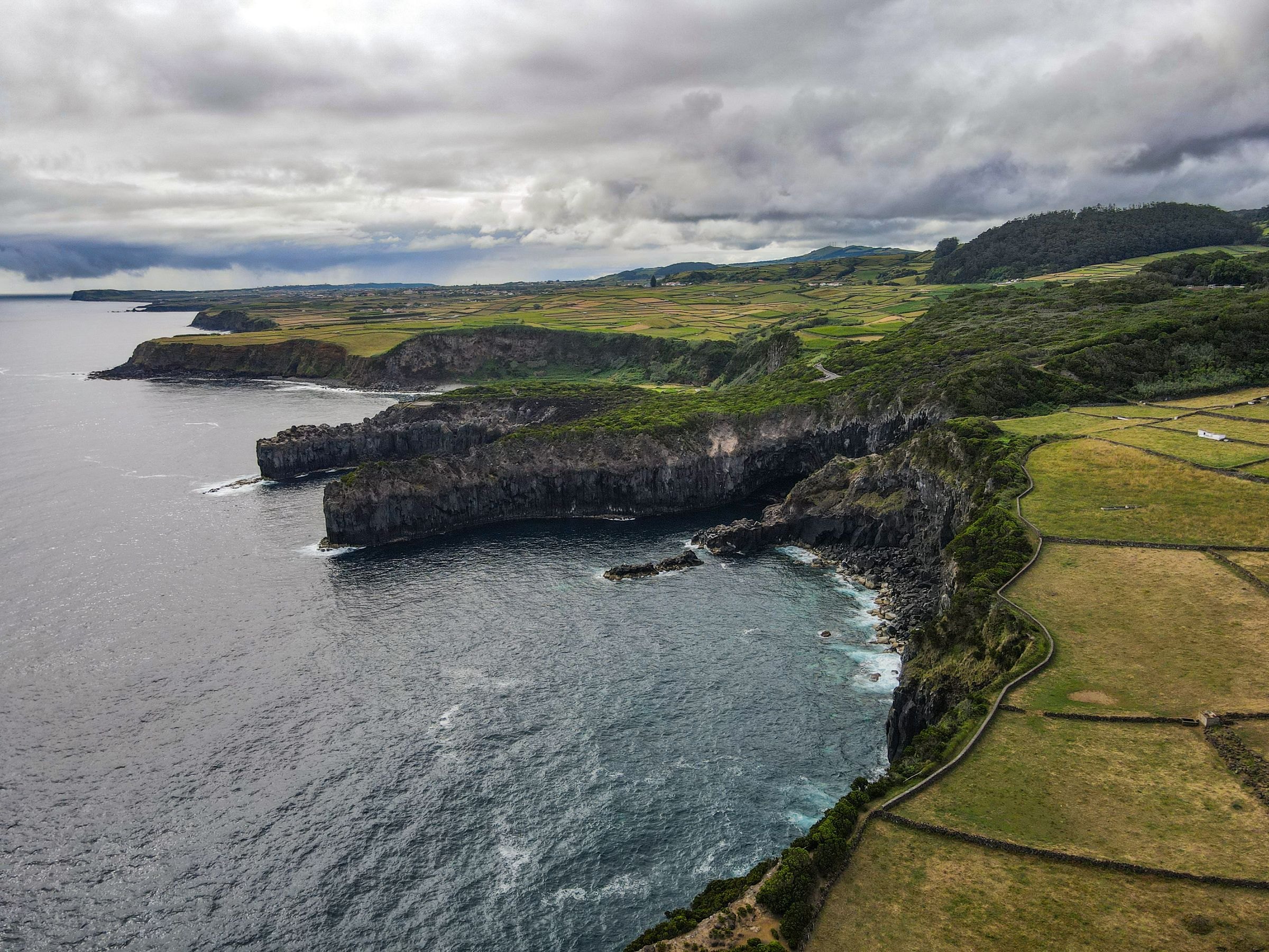 Dramatic coastal cliffs and green fields in the Azores