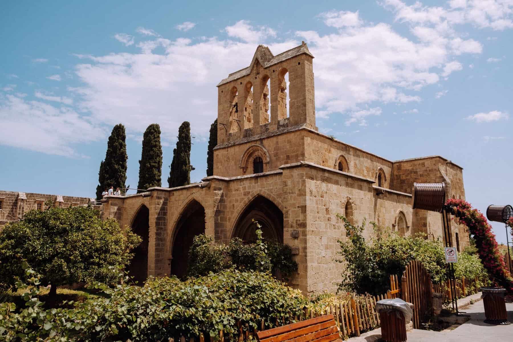 The Gothic ruins of Bellapais Abbey among cypress trees, North Cyprus