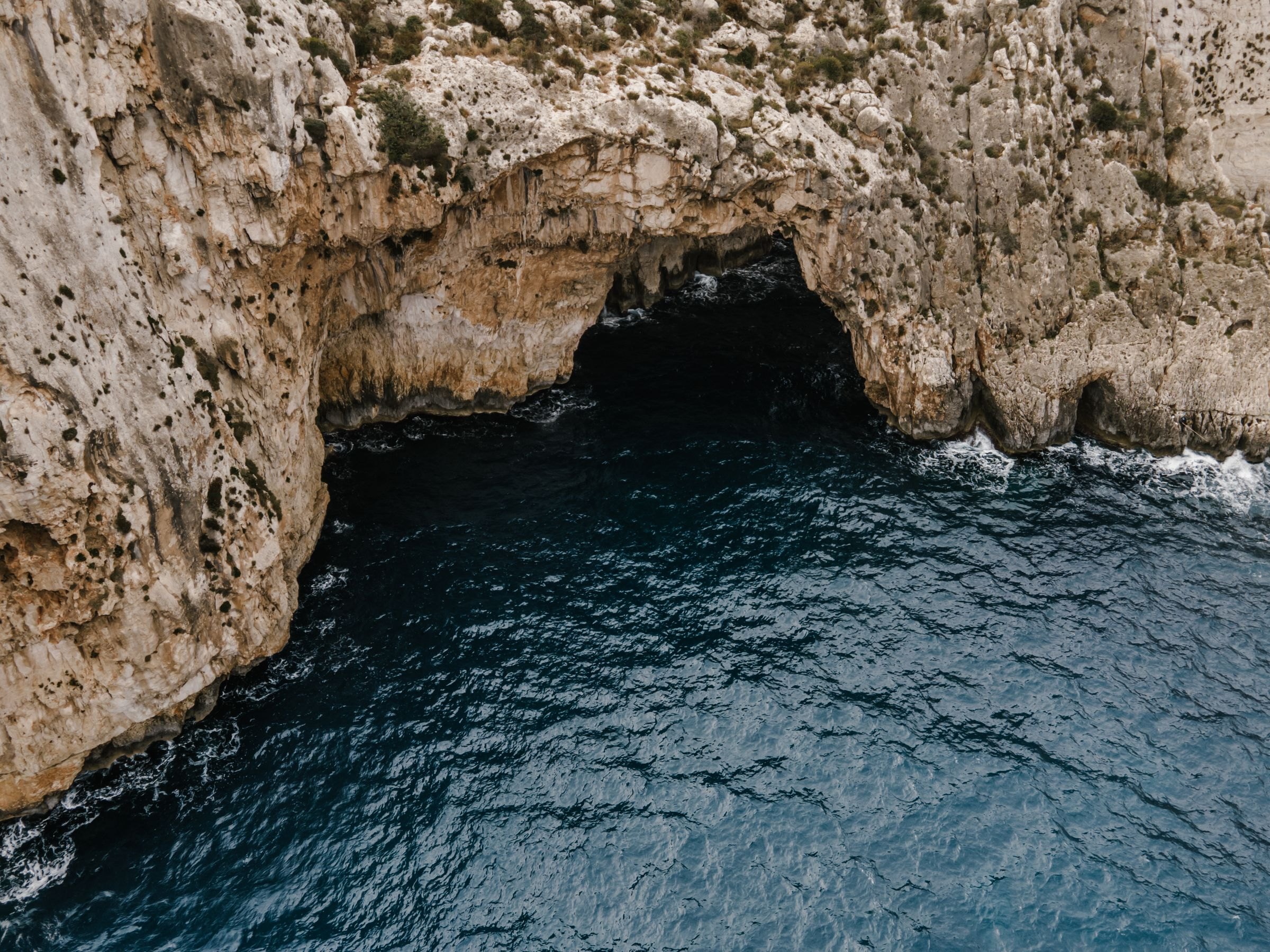 The cliffs and sea caves of the Blue Grotto