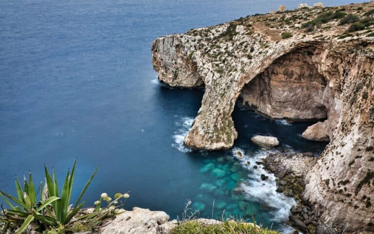 The Blue Grotto above clear blue water, Malta