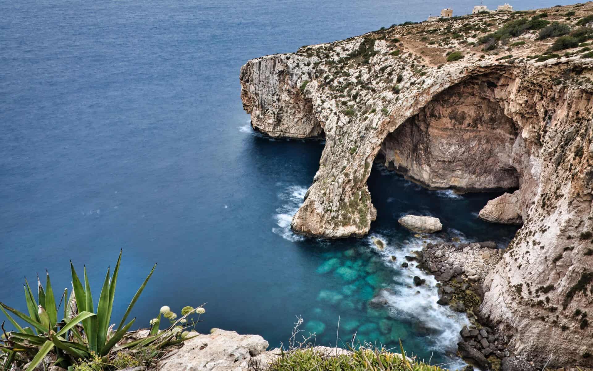 The Blue Grotto above clear blue water, Malta