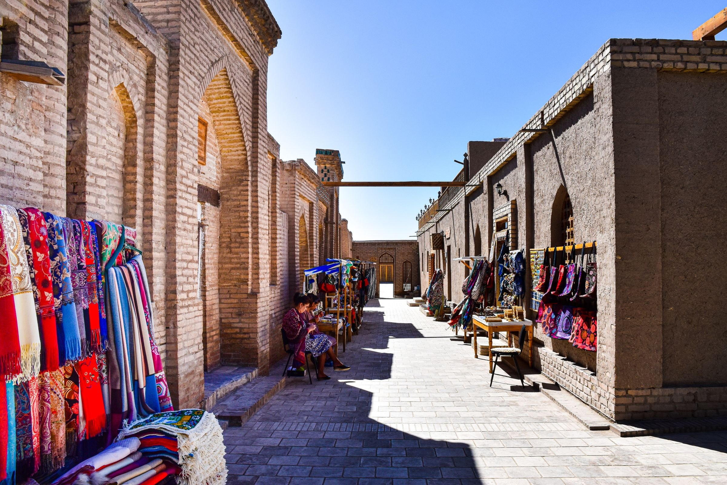 A bazaar alley lined with textiles in Bukhara