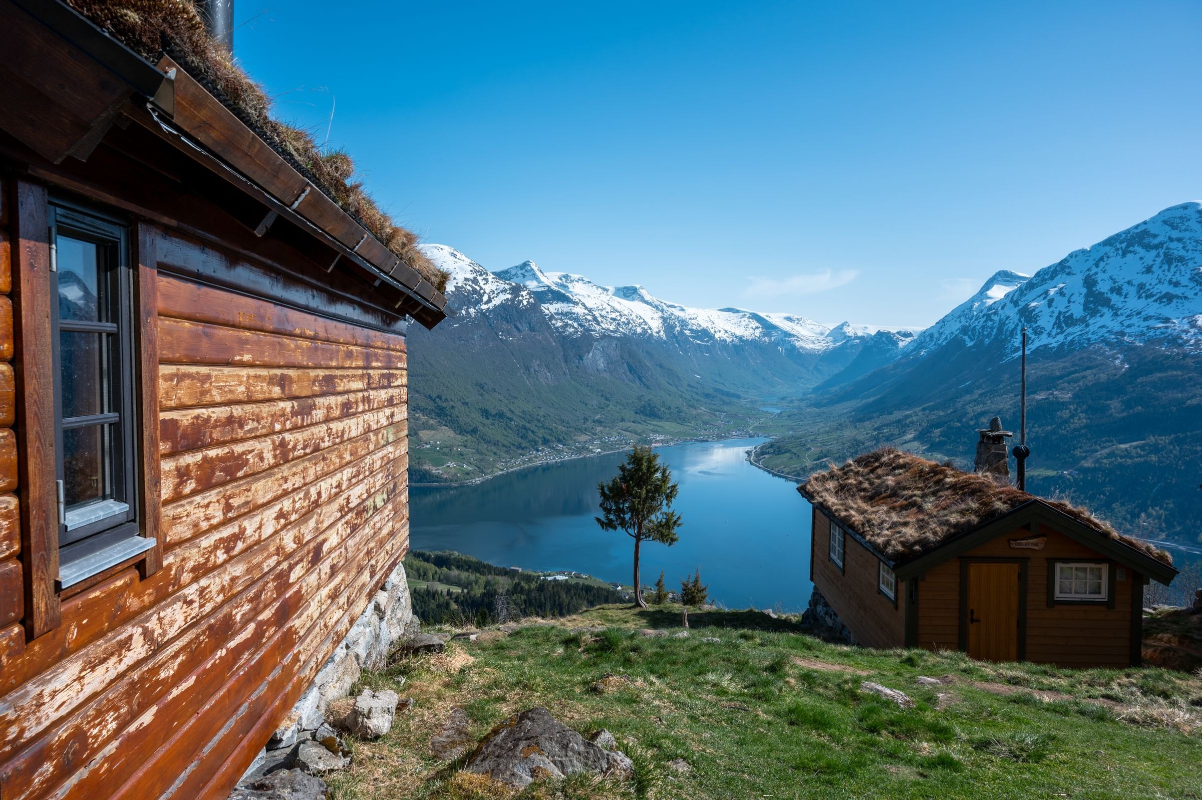 Wooden cabins above a fjord in western Norway