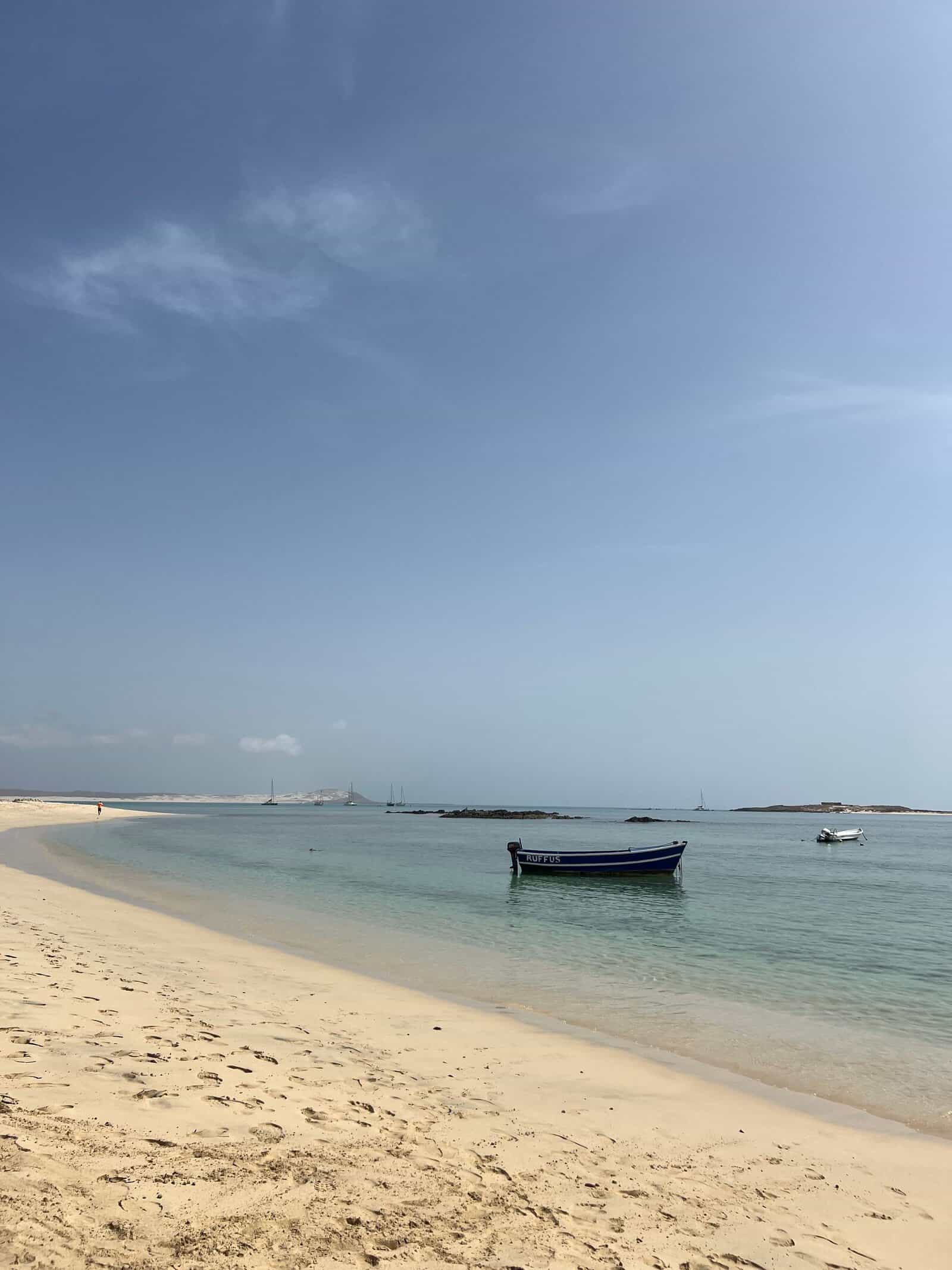 A boat on turquoise water off the beach at Sal Rei, Boa Vista, Cape Verde