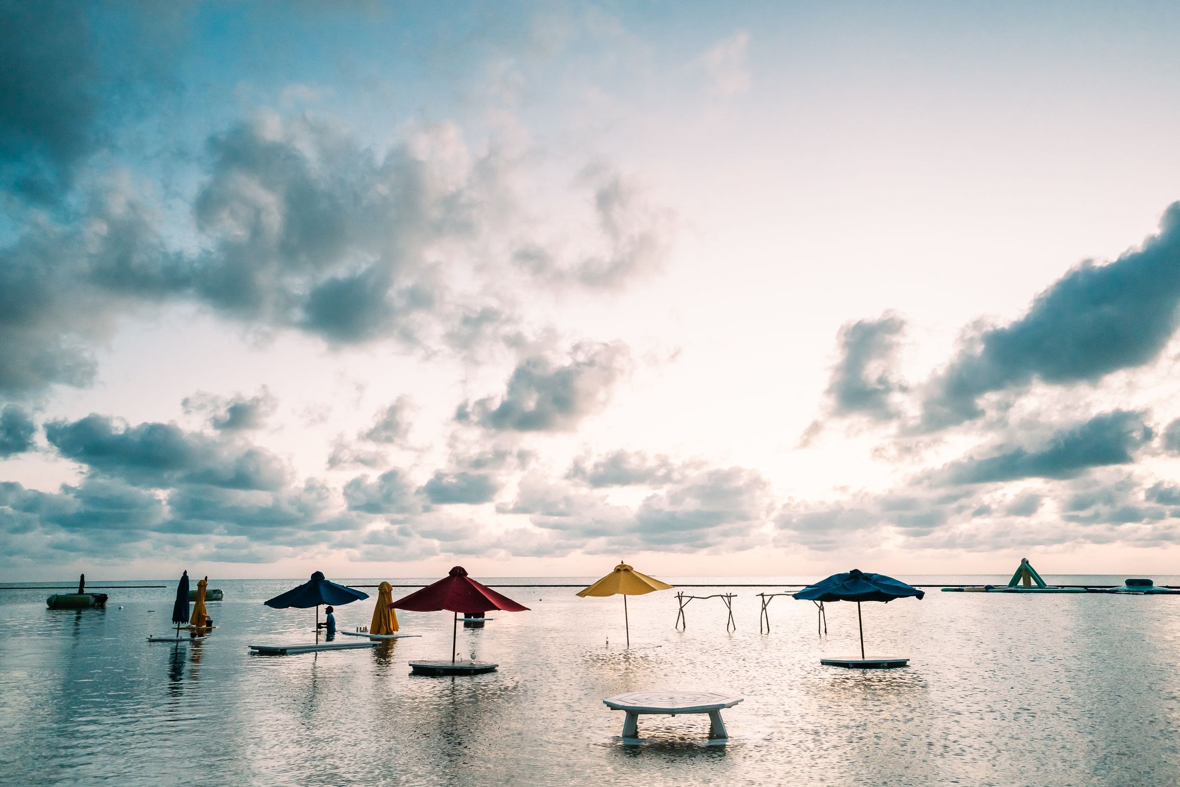 Colourful parasols in the sea off Caye Caulker