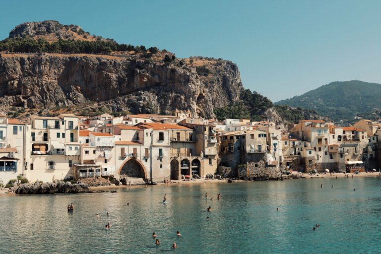 Swimmers below the old town of Cefalù