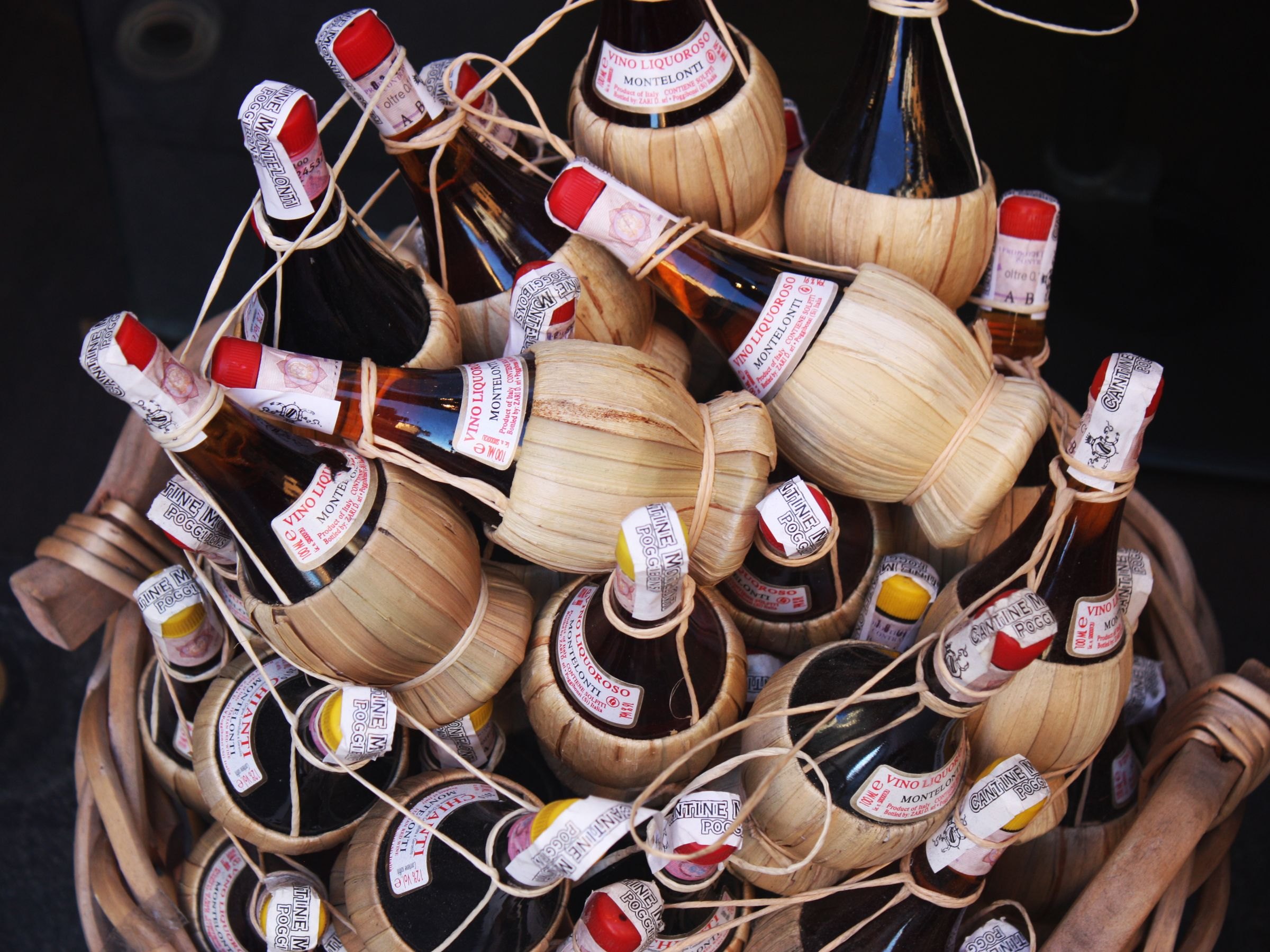 Traditional Chianti wine bottles in straw baskets