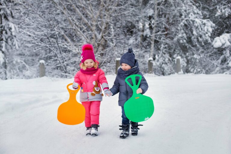 Children with sleds on a snowy day