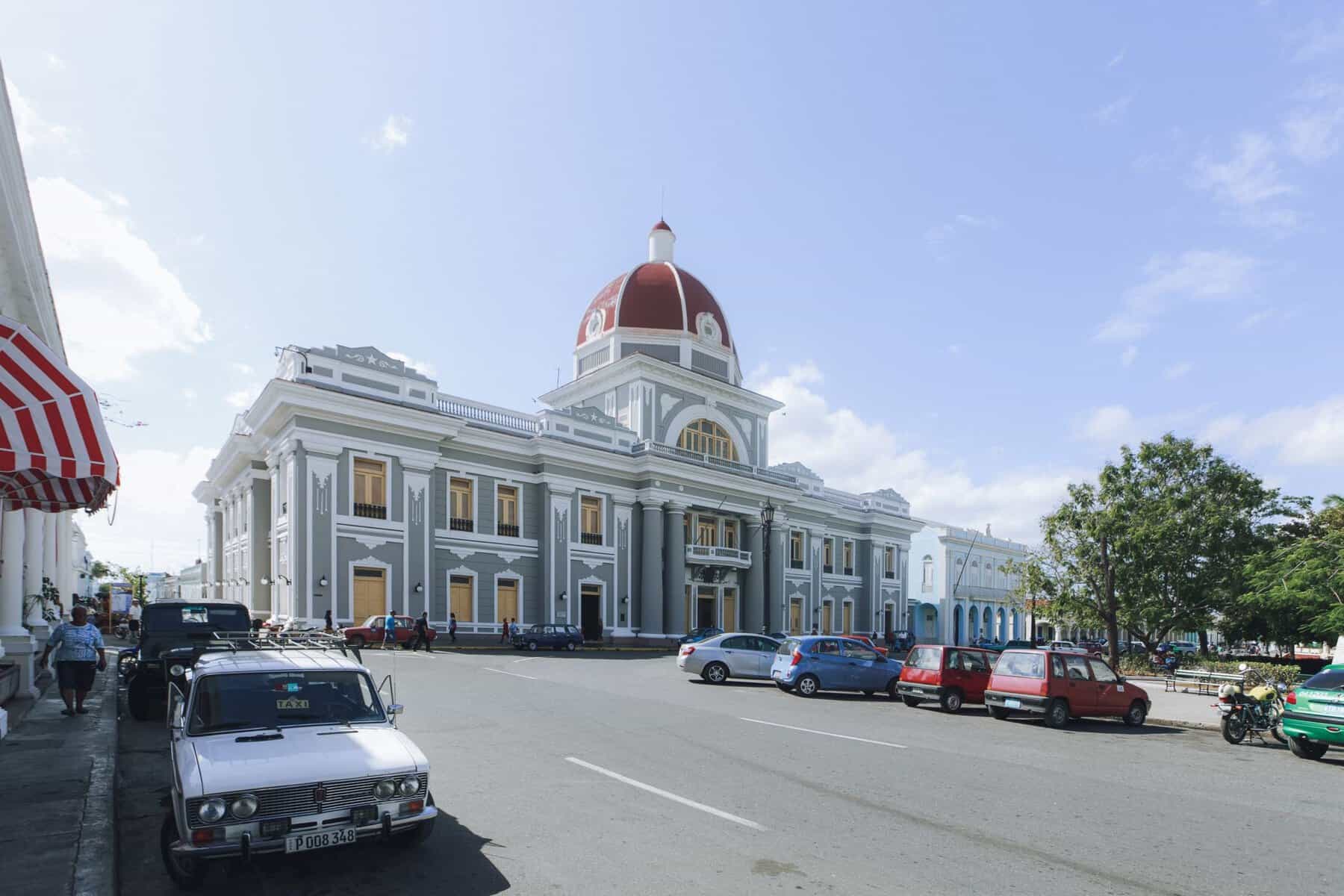 A historic building with a red dome in Cienfuegos, Cuba
