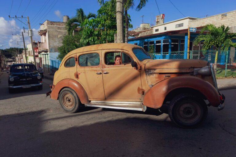 A classic car on a colourful Cuban street