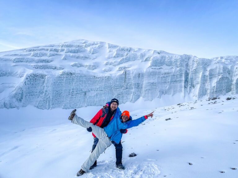 Two climbers celebrating on the glaciers of Kilimanjaro