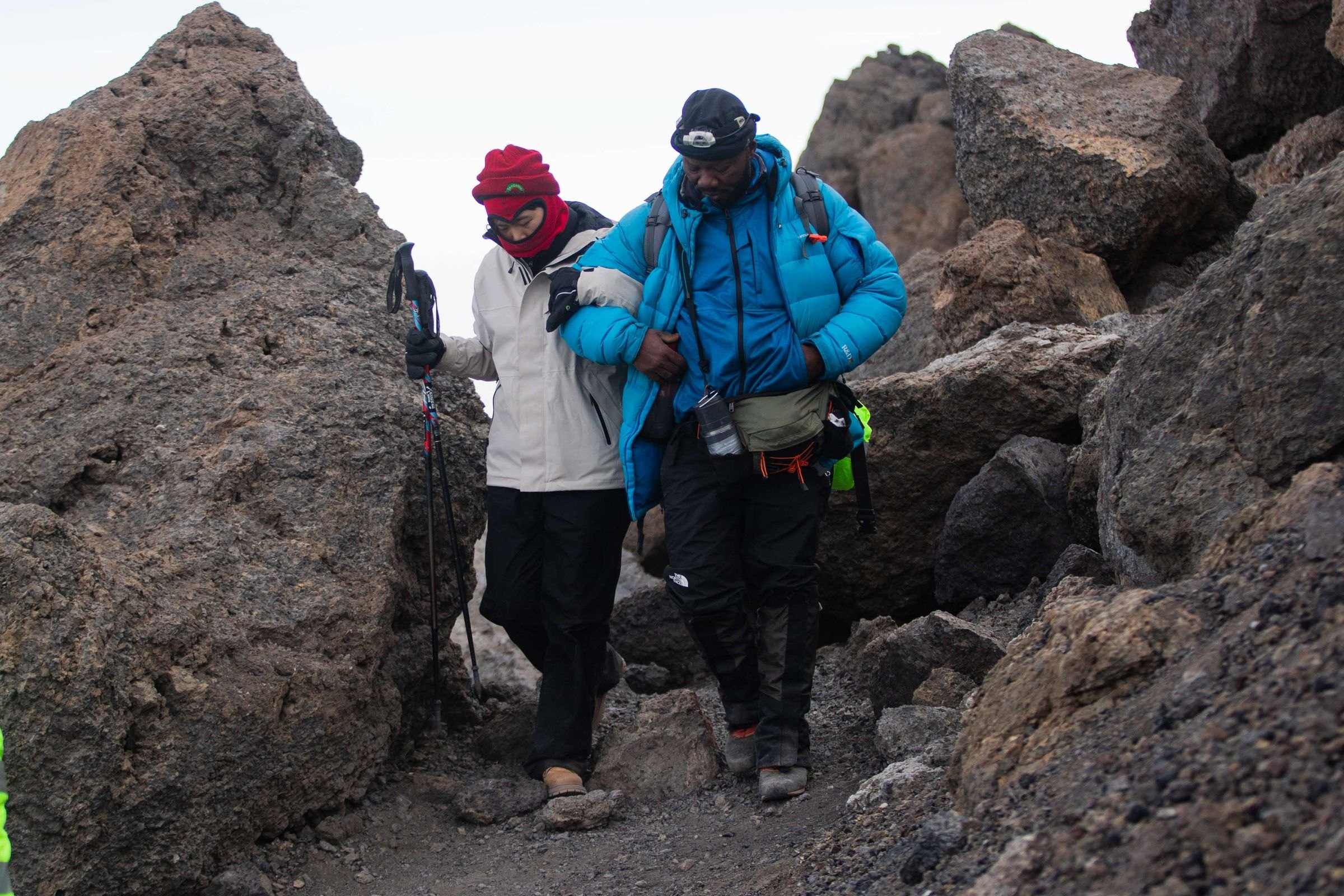 Two climbers picking their way down a rocky section on Kilimanjaro