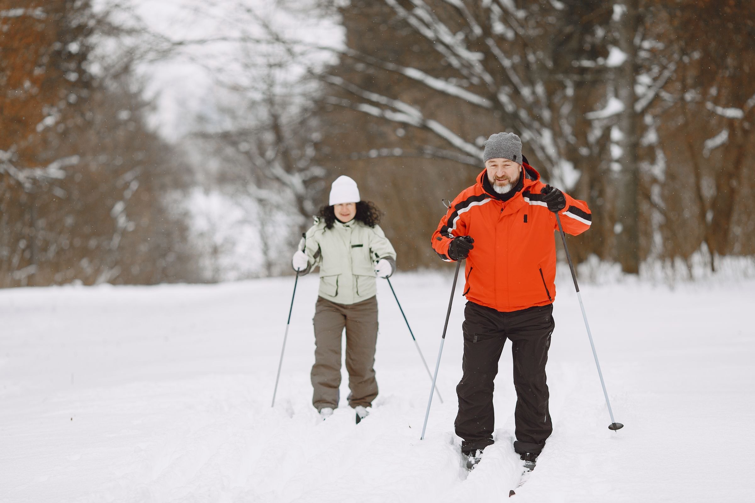 Cross-country skiing through a snowy forest