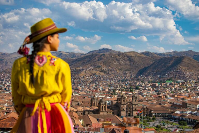 A woman in traditional dress above Cusco
