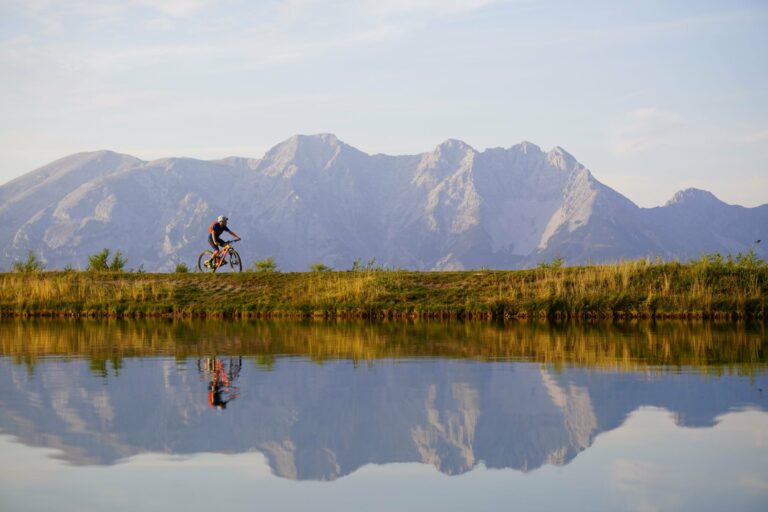 A cyclist riding beside an Austrian lake