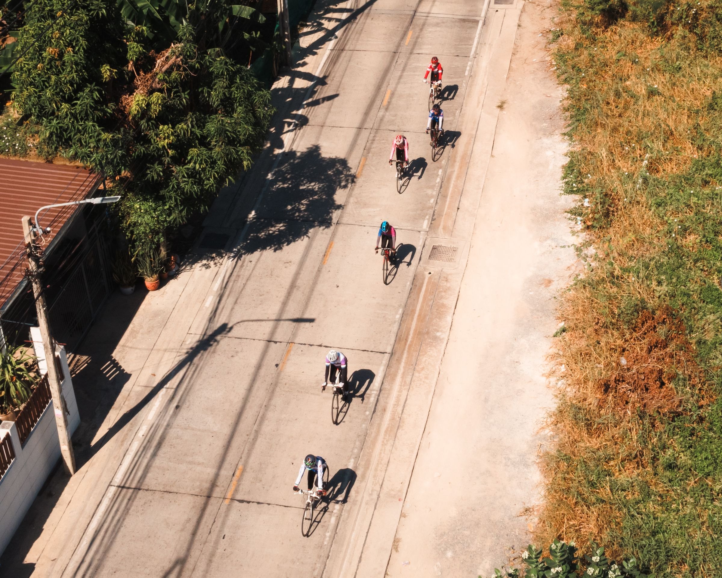 Cyclists riding on a road in Thailand
