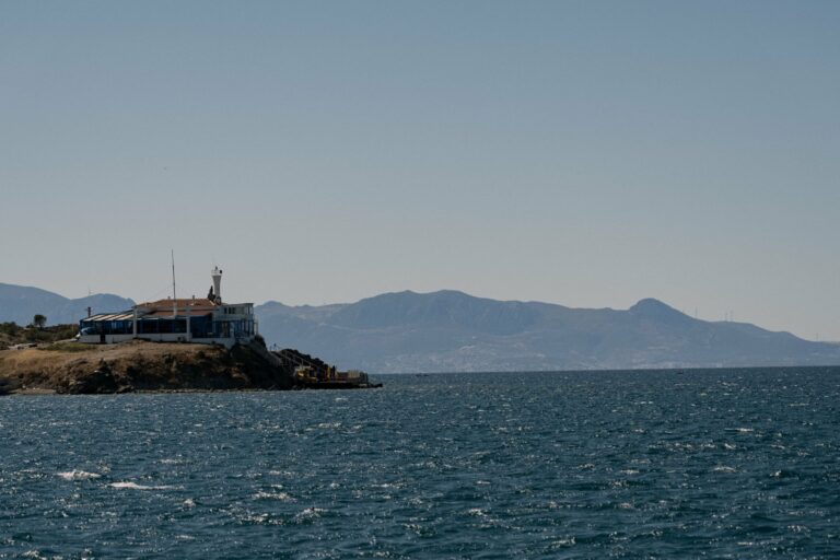 A building on a rocky point above the sea