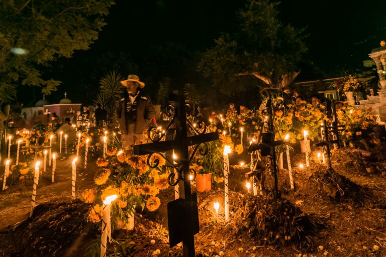 Candles lighting graves on the Day of the Dead