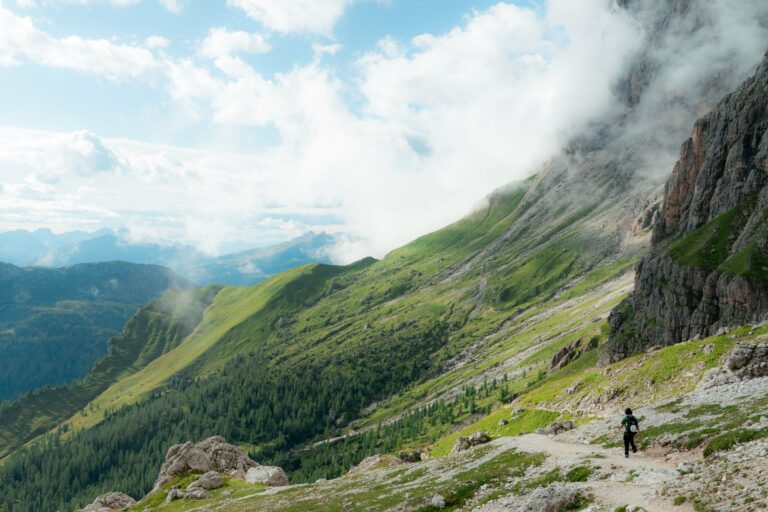 A hiker on a trail in the Dolomites