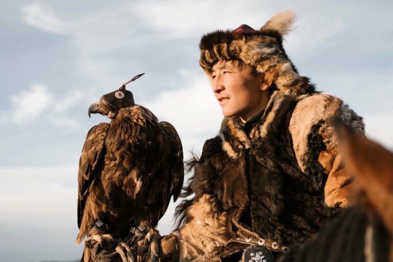 An eagle hunter in fur with his golden eagle