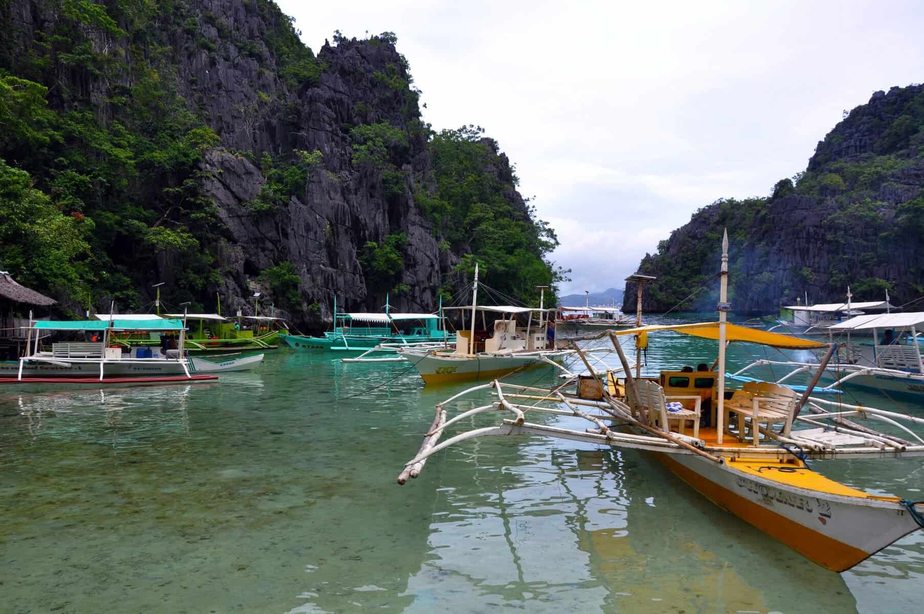 Traditional boats on clear water in El Nido