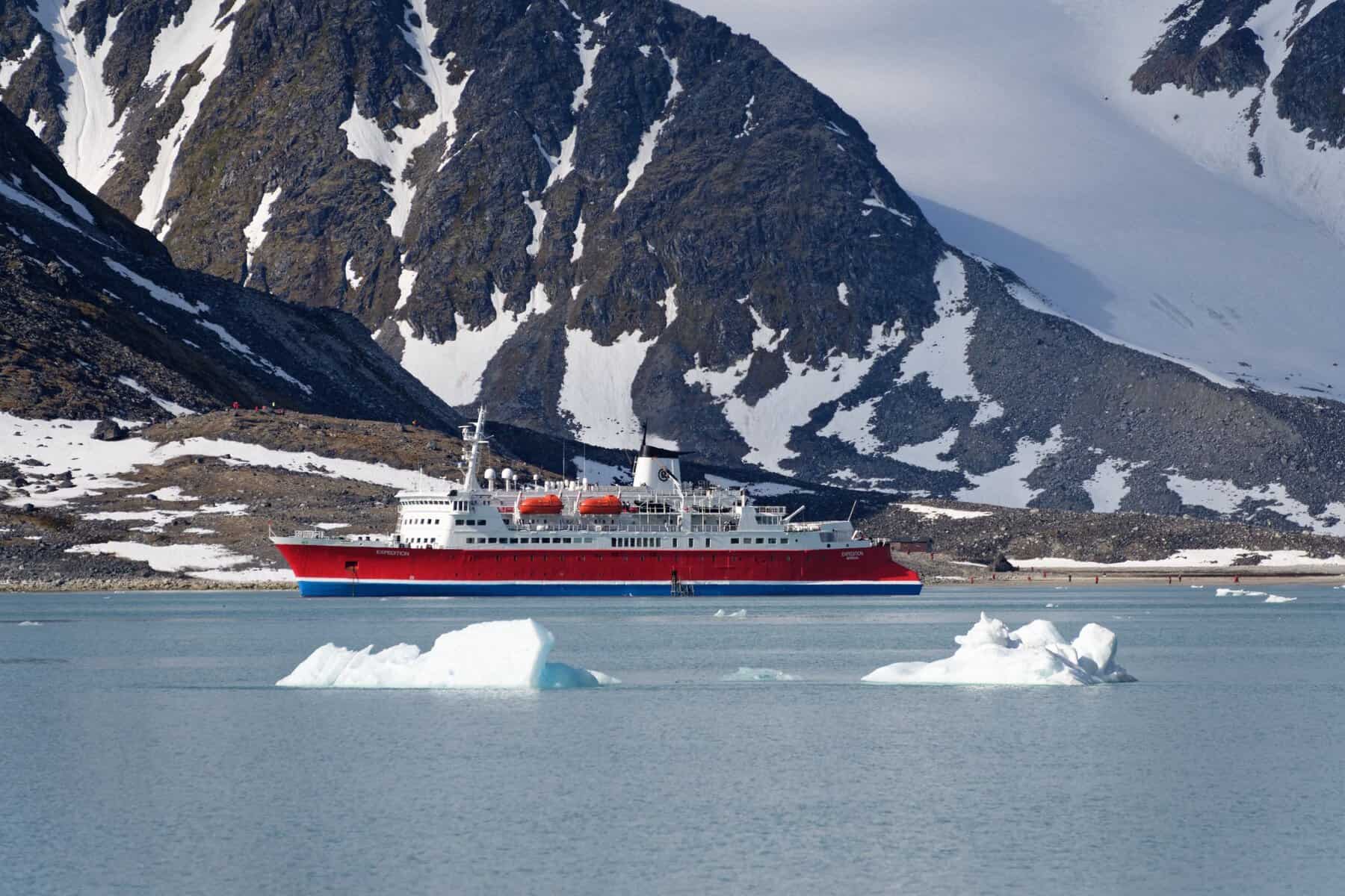 An expedition ship among ice and snowy mountains