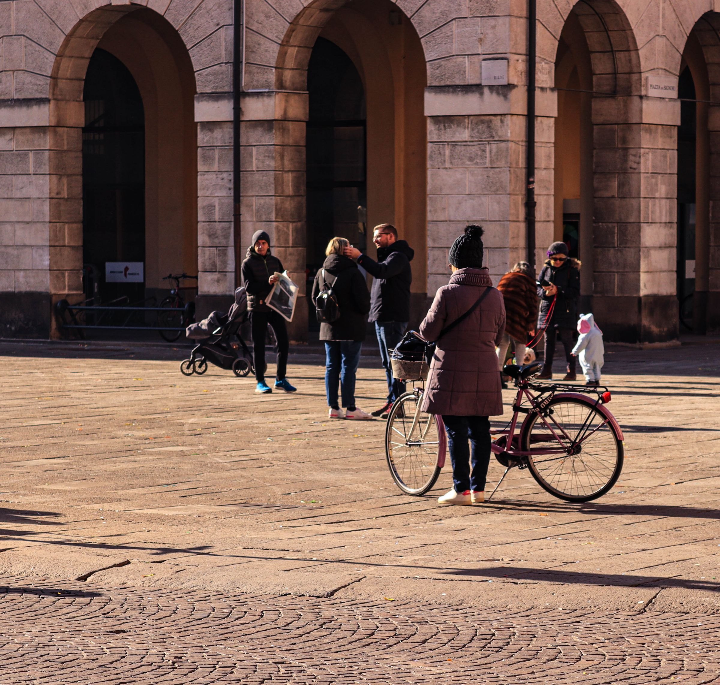 A family in a sunny Italian piazza