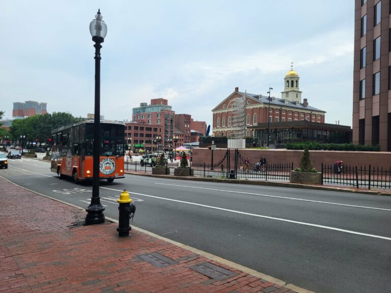 A trolley passing Faneuil Hall in Boston