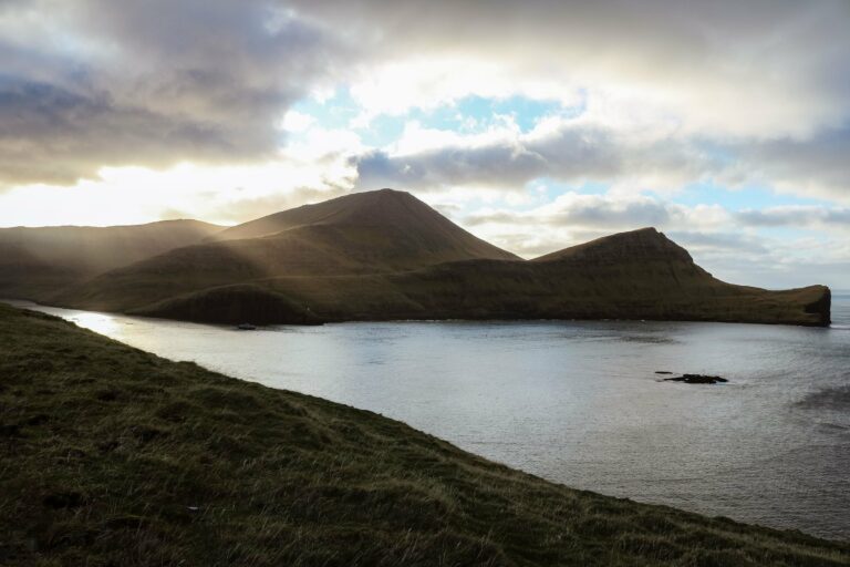Sun breaking through over the Faroe Islands coast