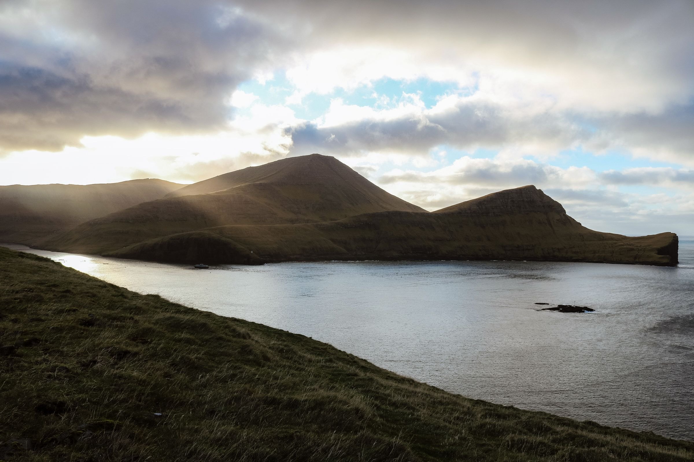Sun breaking through over the Faroe Islands coast