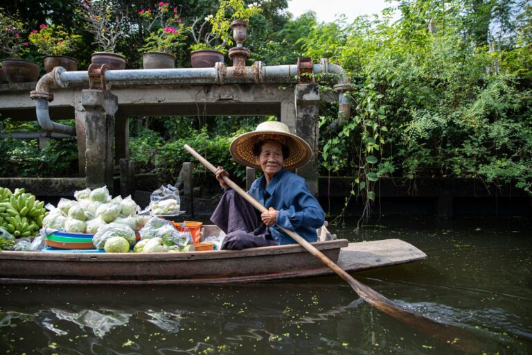 A woman selling produce from her boat at a floating market