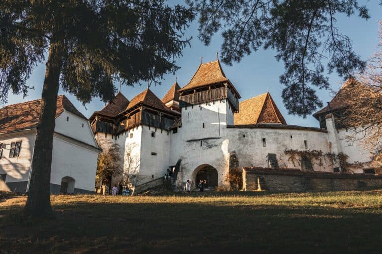 A fortified church in the Romanian countryside at sunset