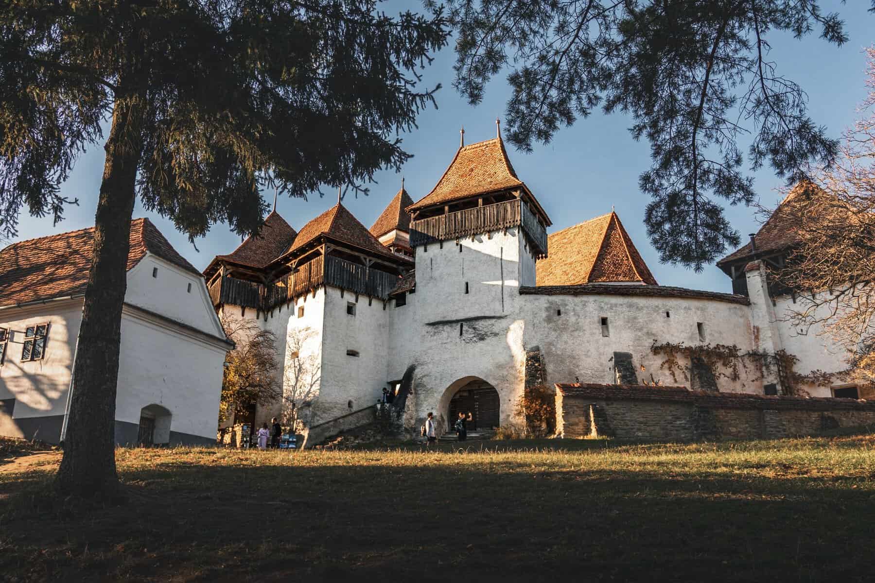 A fortified church in the Romanian countryside at sunset