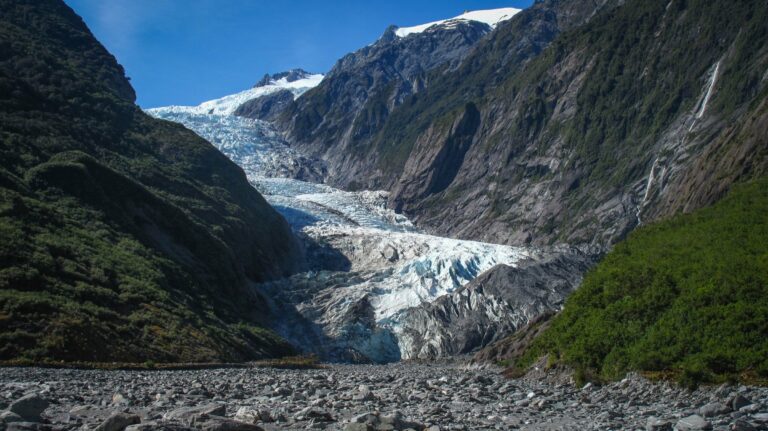 A glacier between rugged mountain valleys